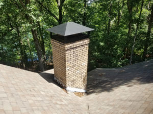 A chimney with a chimney cap for improved ventilation.