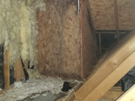 An attic with insulation and chimney services.