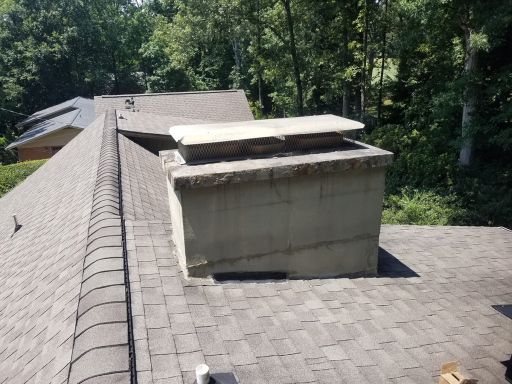 A roof with a chimney for chimney services.