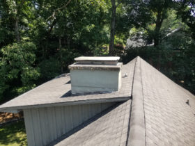 An aerial view of a roof with a chimney and dryer vent services.