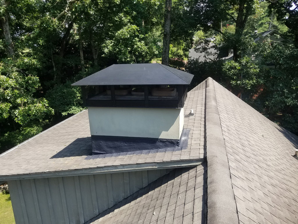 A roof with a chimney and dryer vent services.
