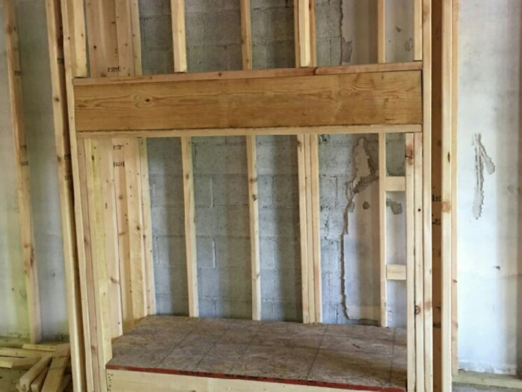 A room being built with wood framing, featuring chimney and dryer vent services.