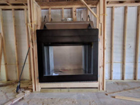 An unfinished room with a chimney and fireplace in it.