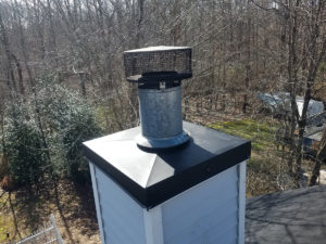 A chimney with a chimney cap for chimney services.
