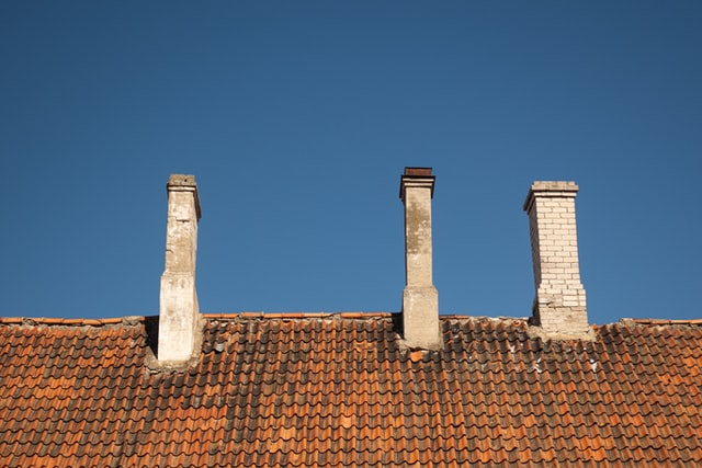 Three chimneys on top of the house